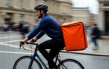 On-demand delivery cyclist in London streets